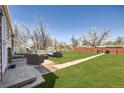 Spacious backyard with lush green grass, a patio area, and cozy outdoor seating, perfect for relaxing and entertaining at 1480 S Osceola St, Denver, CO 80219