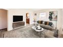 Bright living room featuring contemporary furnishings, lots of natural light, and open access to the kitchen at 1480 S Osceola St, Denver, CO 80219