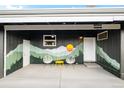 Outdoor garage patio with art and seating, perfect for relaxation and gatherings at 7991 Stuart St, Westminster, CO 80030