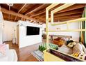 Open living room featuring hardwood floors, beamed ceilings, modern decor, and an inviting space at 7991 Stuart St, Westminster, CO 80030