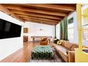 Bright living room with hardwood floors, beamed ceilings, and a comfortable seating area at 7991 Stuart St, Westminster, CO 80030