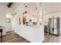 Bright, modern kitchen with stainless steel appliances and stone backsplash at 17979 E Oxford Pl, Aurora, CO 80013