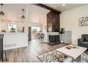 Spacious living room with hardwood floors, stylish decor, and a modern fireplace at 17979 E Oxford Pl, Aurora, CO 80013