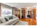 Comfortable living room featuring a plush sofa, hardwood floors, and large window with natural light at 2785 Skyline Dr, Westminster, CO 80030