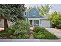Charming two-story home featuring a welcoming front porch and a well-manicured yard at 236 W Sycamore Ln, Louisville, CO 80027