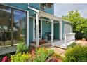 Inviting front entrance with a covered porch and colorful flowerbeds at 236 W Sycamore Ln, Louisville, CO 80027