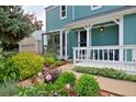Home's entry with a well-maintained porch and beautiful landscaping at 236 W Sycamore Ln, Louisville, CO 80027