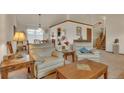 Comfortable living room with vaulted ceilings, neutral colors, and two beige armchairs at 2038 S Hoyt Way, Lakewood, CO 80227