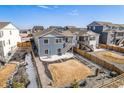 Backyard featuring a concrete patio with stairs leading to a two-story home, surrounded by a well-maintained lawn at 6664 Merrimack Dr, Castle Pines, CO 80108