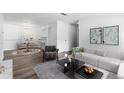 Bright living room features modern decor, wood floors and comfortable seating for a relaxing atmosphere at 7220 S Gaylord St # G17, Littleton, CO 80122