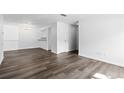 Spacious open-concept living room offers hardwood floors and bright white walls at 7220 S Gaylord St # G17, Littleton, CO 80122