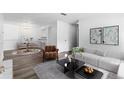 Inviting living room boasts neutral colors, contemporary furnishings, and stylish decor at 7220 S Gaylord St # G17, Littleton, CO 80122