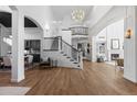 Grand foyer with a soaring ceiling, a stunning chandelier, and hardwood floors at 948 Buffalo Ridge Rd, Castle Pines, CO 80108