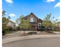 Charming two-story home with stone accents, a two-car garage, and a well-manicured front yard at 948 Buffalo Ridge Rd, Castle Pines, CO 80108