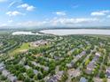 A beautiful aerial view of the neighborhood showcasing the lush green trees and expansive lake at 5660 S Eaton St, Littleton, CO 80123