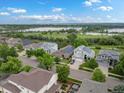 An aerial view of a residential neighborhood with a lake, lush trees, and well-maintained homes at 5660 S Eaton St, Littleton, CO 80123