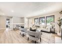 Spacious living room with ample natural light and stylish seating arrangement showcases an inviting living space at 3750 S Fairplay Way, Aurora, CO 80014