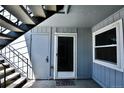 The entrance to this unit features a storm door, welcome mat, outdoor stairs, and a secure closet for storage at 7185 S Gaylord St # A, Littleton, CO 80122