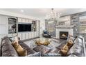 Cozy living room featuring a stone fireplace, built-in shelves, and a large leather sectional at 2627 Hillcroft Ln, Castle Rock, CO 80104