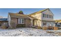 Well-maintained home with a blend of brick and siding, complemented by mature landscaping and a two-car garage at 7009 S Forest Ct, Centennial, CO 80122
