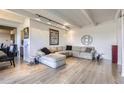 Spacious living room with stylish decor, track lighting, and ample seating for entertaining at 7877 E Mississippi Ave # 506, Denver, CO 80247