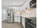 Updated kitchen with stainless steel appliances and white cabinetry at 165 S Sable Blvd # R14, Aurora, CO 80012
