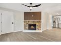 Living room with a stone fireplace and wood accent wall at 165 S Sable Blvd # R14, Aurora, CO 80012