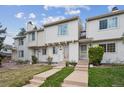 Charming townhome featuring a well-maintained lawn and a welcoming entrance with concrete steps and neutral-colored siding at 4117 S Mobile Cir # C, Aurora, CO 80013