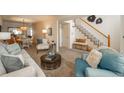 Stylish living room with neutral tones, comfortable seating, and modern staircase at 2145 S Lincoln St, Denver, CO 80210