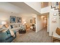 Bright living room with modern decor, plush seating, and stairway access at 2145 S Lincoln St, Denver, CO 80210