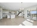 Open concept living space with modern kitchen, dining area, and access to a balcony at 5722 Farrier Pt, Castle Rock, CO 80104