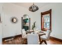 Charming dining area features hardwood floors, stylish lighting, and access to the kitchen at 320 E Dakota Ave, Denver, CO 80209