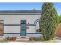 Charming home featuring a decorated front door, landscaped yard, and classic architectural details at 320 E Dakota Ave, Denver, CO 80209