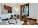 Cozy living room with hardwood floors, stylish furniture, and a large window for natural light at 320 E Dakota Ave, Denver, CO 80209