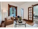 Inviting living room with hardwood floors, designer furniture, and a cozy atmosphere for relaxation at 320 E Dakota Ave, Denver, CO 80209