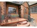 Inviting front porch with seating area and flower box, perfect for relaxing outdoors at 1419 Dexter St, Denver, CO 80220