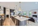 Open-concept kitchen showcasing a spacious island, modern appliances, and seamless flow to the living area at 3019 Chase St, Wheat Ridge, CO 80214