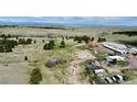 Aerial shot featuring a horse arena, multiple outbuildings, and lush green pasture at 1740 Michael Gates Dr, Parker, CO 80138
