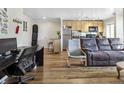 Open concept living space features hardwood floors, a modern kitchen and living room at 1450 Albion St # 206, Denver, CO 80220