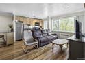 Bright living space showcases hardwood floors, neutral paint, and views from the large window at 1450 Albion St # 206, Denver, CO 80220