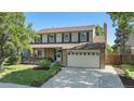 Charming two-story home with landscaped yard, brick accents, and two-car garage at 1121 W Kettle Ave, Littleton, CO 80120