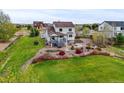 Expansive backyard with deck, patio, fire pit and landscaped garden at 42225 Kingsmill Cir, Elizabeth, CO 80107