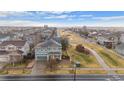 Aerial shot of a two-story home with solar panels in a neighborhood near a walking trail and open space at 4797 Longs Peak St, Brighton, CO 80601