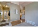 Welcoming entryway features hardwood floors and a view of the staircase at 9659 Autumnwood Pl, Highlands Ranch, CO 80129