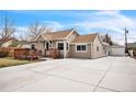Exterior of a charming home, featuring a long driveway and a detached garage at 3656 W 77Th Ave, Westminster, CO 80030