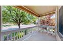 Inviting front porch with white railing and a serene view of the neighborhood at 1936 E 144Th Dr, Thornton, CO 80602