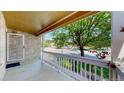 Charming front porch offering a peaceful view of the tree-lined street at 1936 E 144Th Dr, Thornton, CO 80602