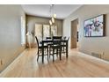 Bright dining room with hardwood floors, natural light, and contemporary light fixture at 2885 W 115Th Dr, Denver, CO 80234
