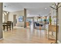 Open-concept living area featuring hardwood floors and neutral tones and a view to the dining and living rooms at 2885 W 115Th Dr, Denver, CO 80234