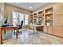Comfortable office with built-in shelves, a large window, and ample workspace at 2885 W 115Th Dr, Denver, CO 80234